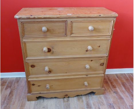 A contemporary pine chest of drawers, having a moulded top above two short and three long drawers raised on bracket feet, 103