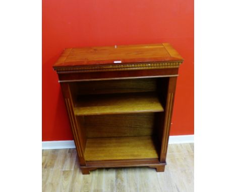 A contemporary yew wood bookcase having a moulded dentil  top above two adjustable shelves raised on bracket feet, 72 x 97cm