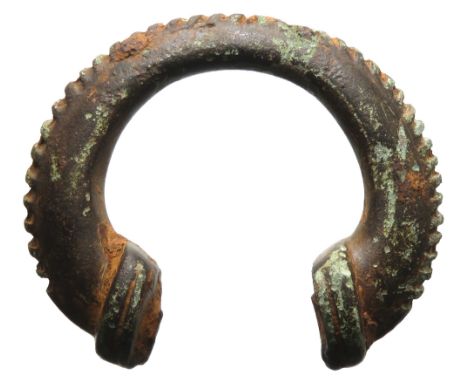 Iron age terret ring. Circa 2nd-1st century BCE. Detailed with a serrated raised central rib that runs around the bow. Missin