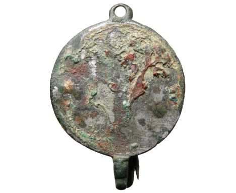 Large roman disc brooch with zoomorphic terminal. Circa 2nd century CE. Complete with pin and catchplate. Copper-alloy, 51mm.