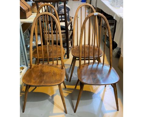 An Ercol drop end dining table on four tapering legs and four Ercol hoop back dining chairs 