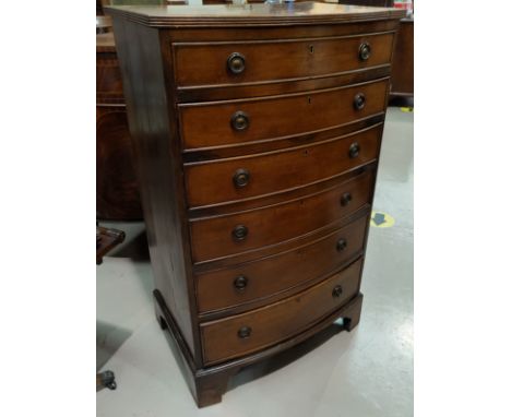 A walnut  reproduction 6 height chest of drawers of narrow proportions, on bracket feet 