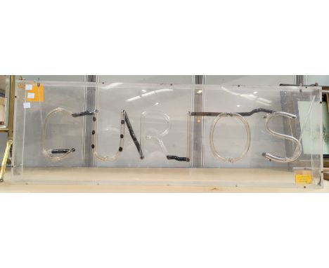 A vintage light up sign 'CURIOS'