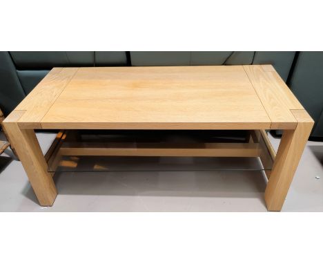 A light oak modern coffee table with glass undershelf 