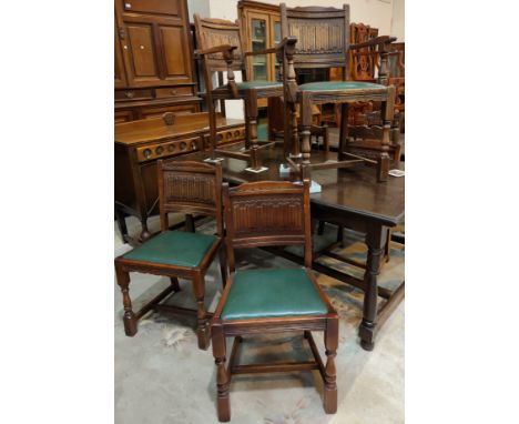 An oak set of six (4+2) dining chairs with linen fold panel backs