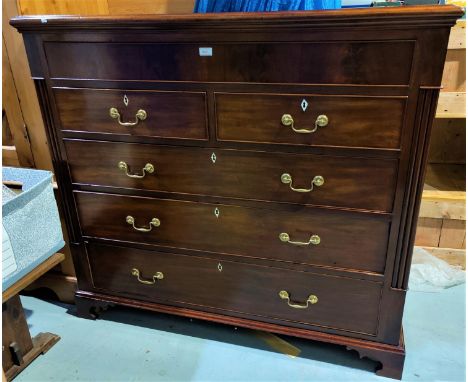 A Georgian mahogany chest of 3 long, 2 short and frieze drawers with brass swan neck handles, square reeded side columns, on 
