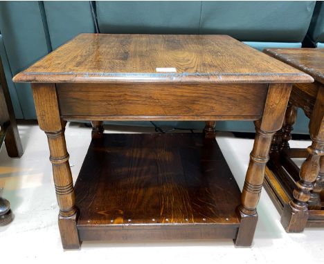 An Oak square coffee table with shelf under and turned legs 