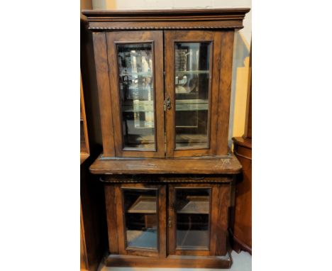 A Victorian walnut display cabinet with double doors above and bellow, with mirror back