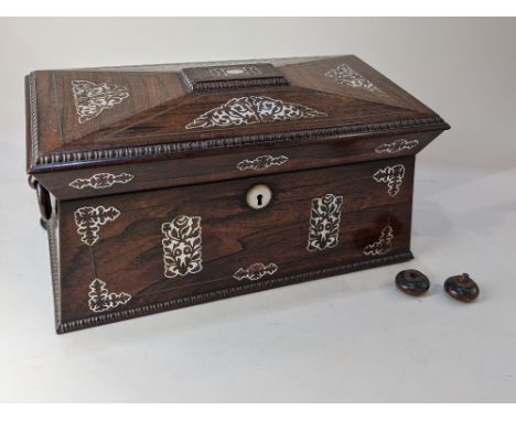A 19th century rosewood and mother of pearl inlaid tea caddy, of sarcophagus shaped form, the hinged lid enclosing two lidded