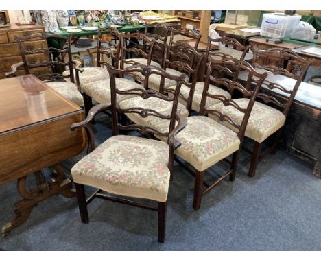 A set of ten Chippendale style ladderback dining chairs, including two carvers, with serpentine top rails and pierced back sp