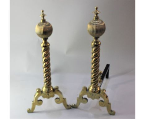 A brass fire fender with pierced front, on three paw feet, 103cm, a pair of brass fire dogs, small trivet, tongs and shovel, 