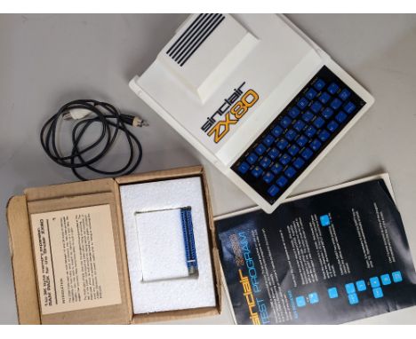 A Sinclair ZX80 early computer, with test program leaflet, circuit diagram, and a 1 to 3K byte memory expansion ram pack 