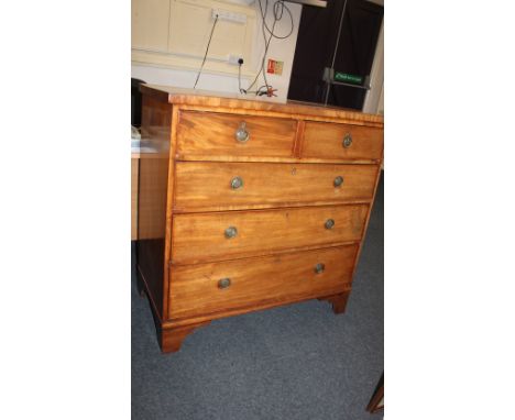A 19th century mahogany flat fronted chest of two short over three long drawers with brass ring handles and fleur de lys embo