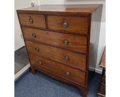 A 19th century mahogany chest of two short over three long drawers, with brass ring handles and circular embossed back plates