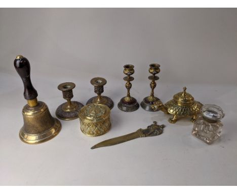 A pair of cloisonne brass candlesticks with floral decoration on yellow and red ground, on circular stone bases, 14cm high, a