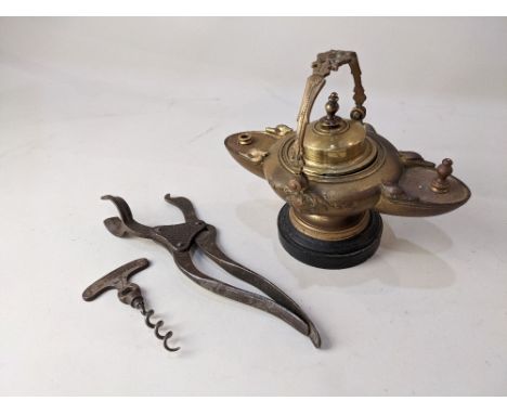 A Victorian Aladdin style brass oil lamp, on circular base, together with a Lund patent tangent lever two section corkscrew