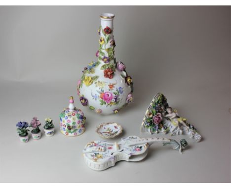 A Dresden porcelain vase, globular form with narrow neck, encrusted with flowers, (a/f) 30cm a cherub wall bracket, a violin 