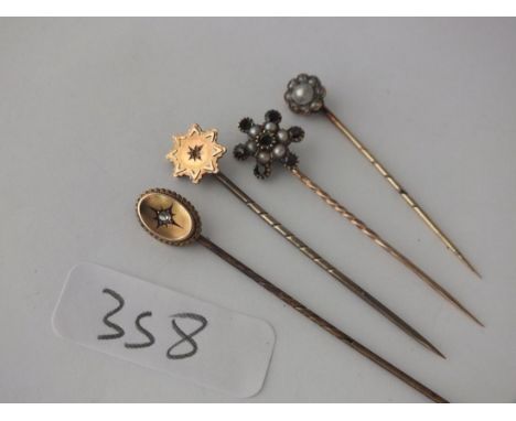 Group of four stick pins       