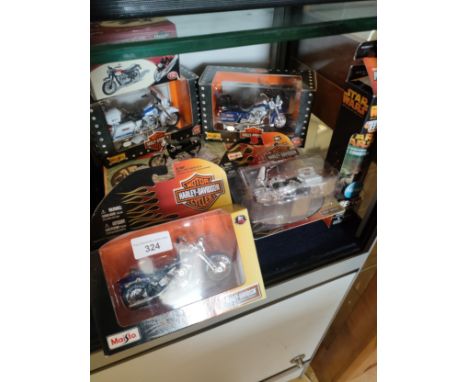 Shelf of Harley Davidson bike models etc magic set etc . 