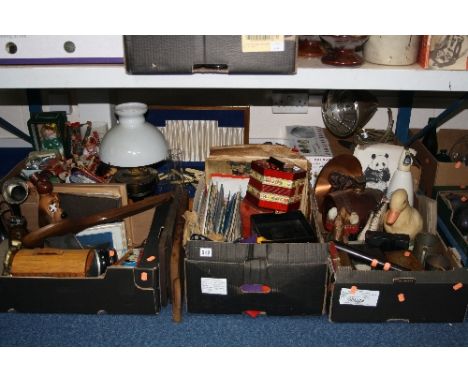 FOUR BOXES AND LOOSE SUNDRY ITEMS, to include oil lamp, gas mask, collectors dolls, cutlery, flags, musical squeeze box, trun