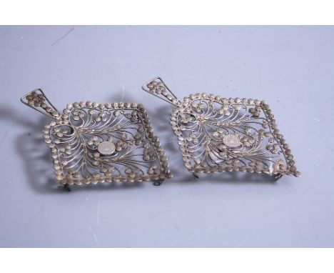 TWO PIERCED AND MOULDED WHITE METAL STANDS, having scrolling central section with medallion, carrying handle, bobbin border, 