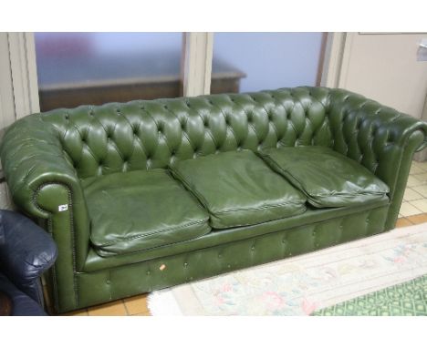 A GREEN LEATHER BUTTON BACK THREE SEATER CHESTERFIELD SOFA