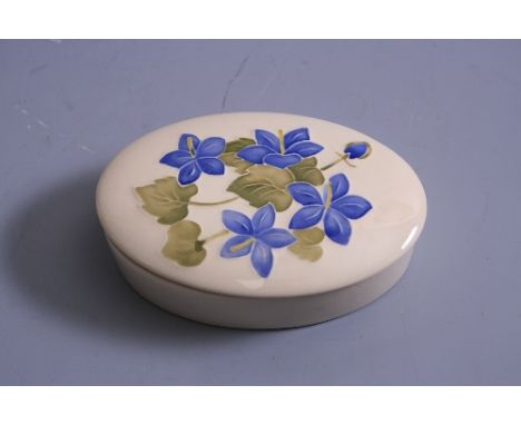 A MOORCROFT POTTERY OVAL TRINKET BOX, Campanula pattern on cream ground, impressed marks to base, length approximately 13cm