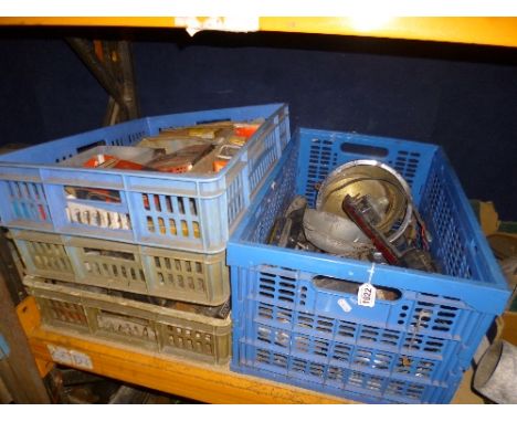 FOUR BOXES OF VINTAGE AUTOMOTIVE PARTS, including bulbs, fanbelts, headlamps, etc