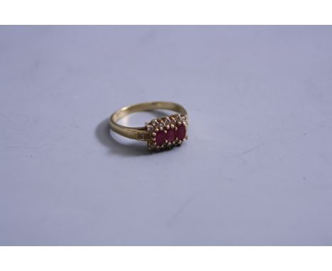 A 9CT THREE STONE RUBY AND DIAMOND CLUSTER RING, ring size R