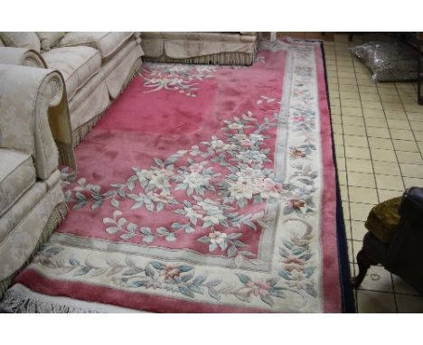 A CHINESE PINK GROUND FLORAL CARPET, approximate size 374cm x 274cm