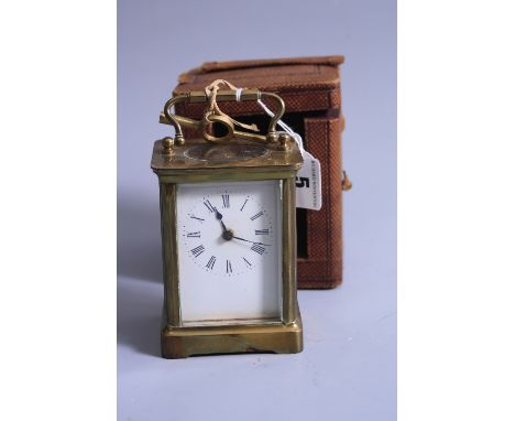 A BRASS CARRIAGE CLOCK, in travelling case (key)