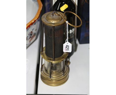 A BRASS AND GAUZE DAVY MINERS LAMP, having brass domed top impressed CLN 206 over tapering central gauze section over burner,