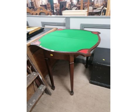 A reproduction mahogany card table raised on spade feet 