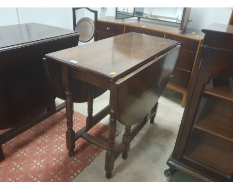 An oak drop leaf and gate leg table