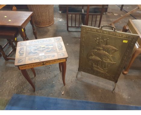An Italian music table and a brass embossed fire screen