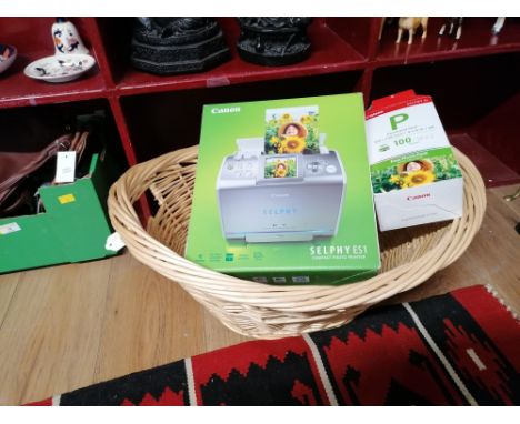 Basket containing Canon ink and paper integrated cartridge and a compact photo printer
