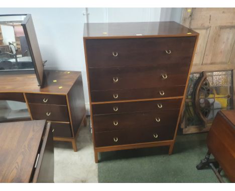 A mid century six drawer chest of drawers with metal ring handles and raised on square section legs 