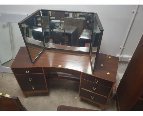 A mid century dressing table with metal ring handles and raised on square section legs 