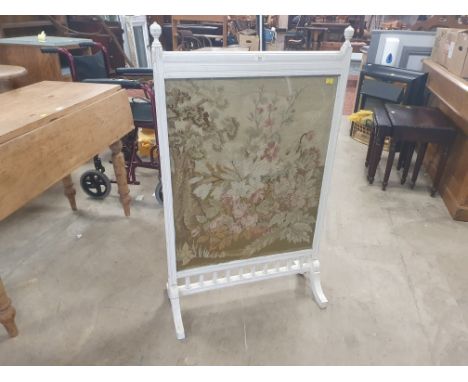 A needlework fire screen in cream painted frame possibly from Corby Castle with catalogue