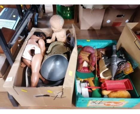 Two boxes of plastic dolls, boxing gloves, and other toys 