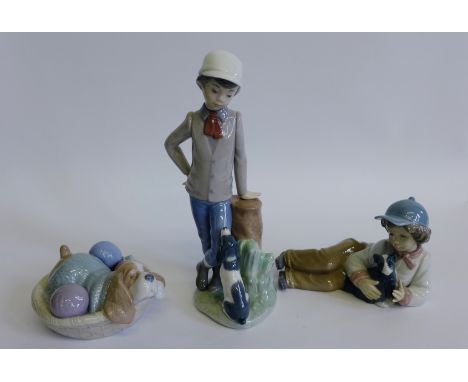 Two Nao porcelain boy and dog  figures and a Nao model of a sleeping dog in a basket (3)