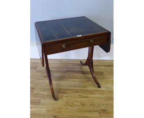 A Victorian sofa table having a moulded top with drop leaves and green leather skiver above freize drawer raised on splade le