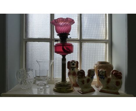 A mixed lot to include a cranberry glass & brass Corinthian oil lamp, cut crystal water jug, Wally Dugs etc. 