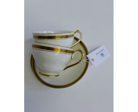 A collection of white glazed and gilt rimmed Greek key patterned tea wares to include cups, saucers, plates and a sugar bowl,