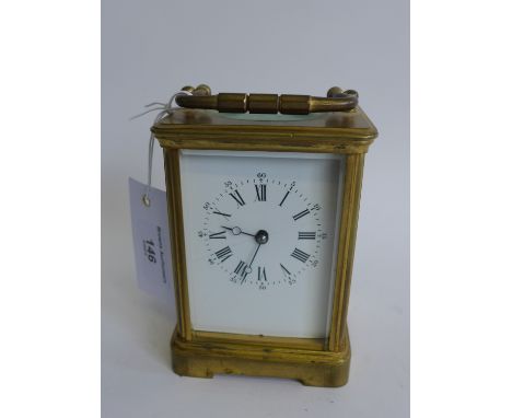 Brass cased carriage clock, the white enamel dial with Roman numerals, complete with key