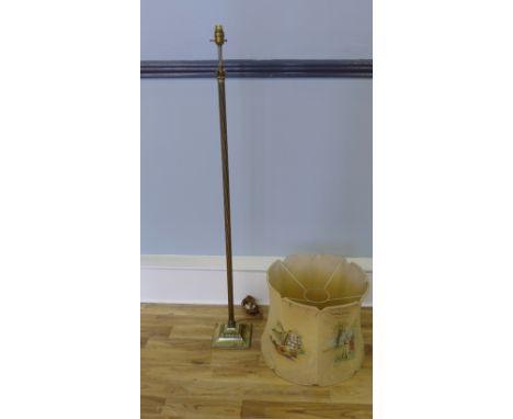 A brass fluted standard lamp complete with shade