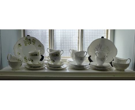 A collection of two bone china six piece tea sets to include cups, saucers, sugar bowl, creamer, sandwich plates etc.