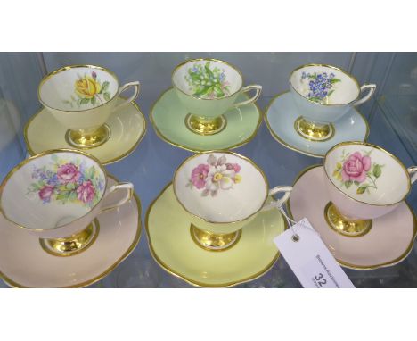 Clare bone china harlequin cups and saucers, each with a different floral spray to cup interior (12)