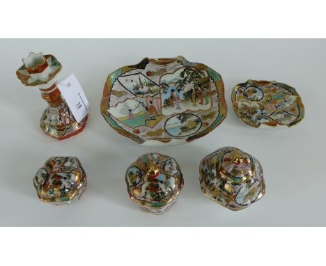 A Japanese porcelain dressing table set comprising a candlestick, three pots with covers and two dishes, all painted with fig