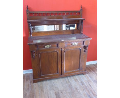 An Edwardian mirror back mahogany sideboard having two short drawers over panel doored cabinets raised on bracket feet, 119 x